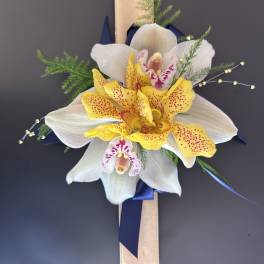 Orchid corsage with white and yellow blooms on a ribboned wristlet
