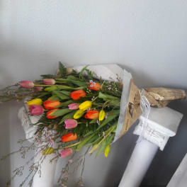 Bouquet of multicolored tulips wrapped in paper