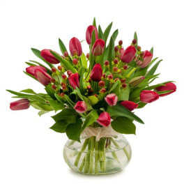 Pink tulip bouquet in a round glass vase