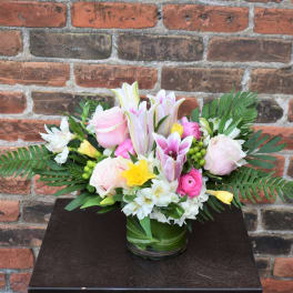 Pink and white mixed flower arrangement in a glass vase