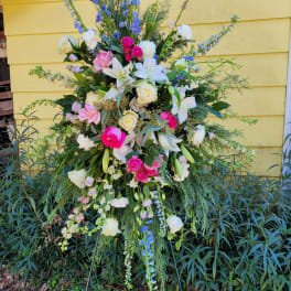 Tall standing floral spray with pink, white, and blue flowers