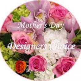 Round bouquet of pink and white roses with green accents