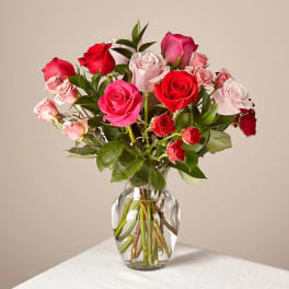 Bouquet of pink and red roses in a clear glass vase