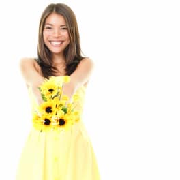 Woman holding a small bouquet of yellow flowers