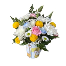 Bouquet of white, yellow, pink, and blue flowers in a giraffe-print mug