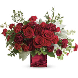 Red roses and carnations in a red glass vase
