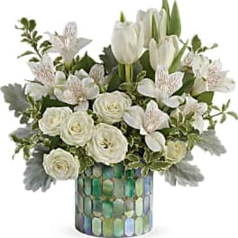 White tulips and roses in a mosaic glass vase
