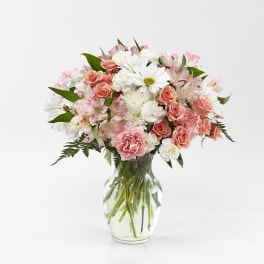 Pink and white mixed bouquet in a clear glass vase