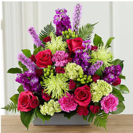 Mixed bouquet of pink and purple flowers in a rectangular vase