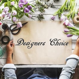 Flat lay of tulips and floral supplies around a paper sign
