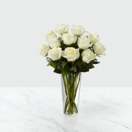 White rose bouquet in a clear glass vase