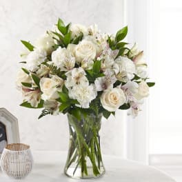 White roses and alstroemeria in a clear glass vase