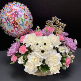 Birthday flower basket with a polka-dot balloon and pink and white blooms