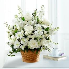 White floral arrangement in a woven basket