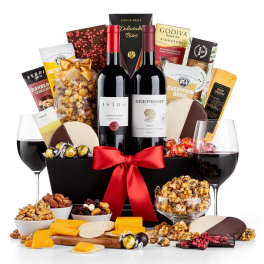 Gift basket with wine, chocolates, snacks, and cheese, tied with a red ribbon