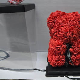 Red rose teddy bear in a clear gift box with a black lid