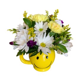 Daisy bouquet in a yellow smiley-face mug