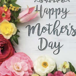 Colorful flower arrangement around a "Happy Mother's Day" sign