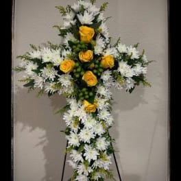 Cross-shaped floral standing spray with white daisies and yellow roses