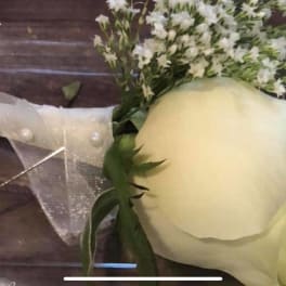 White rose boutonniere with pearl pins and sheer ribbon