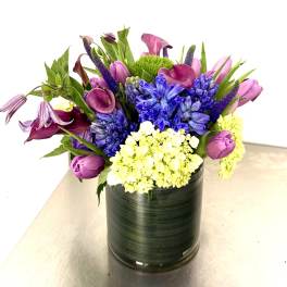 Colorful bouquet in a black cylindrical vase