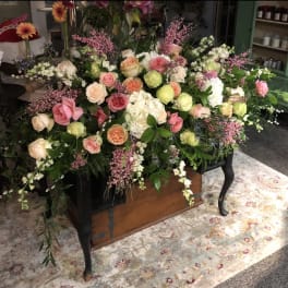 Large floral casket spray with pink and peach roses