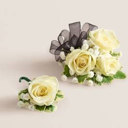 Cream rose boutonniere and matching floral cluster with black ribbon