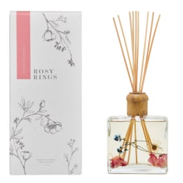 Floral reed diffuser with a clear glass bottle and pink-accented packaging