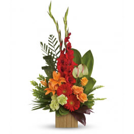 Tall red and orange floral arrangement in a wooden rectangular vase