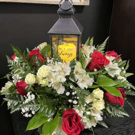 Red and white rose arrangement with a lantern centerpiece