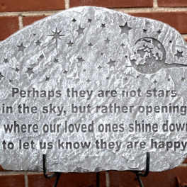 Decorative memorial stone with engraved stars and a quote