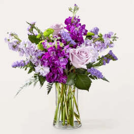 Lavender and purple bouquet in a clear glass vase