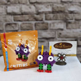 Toy building-block critter and its orange packaging on a table