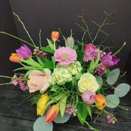Mixed bouquet with roses, tulips, and a pink gerbera daisy