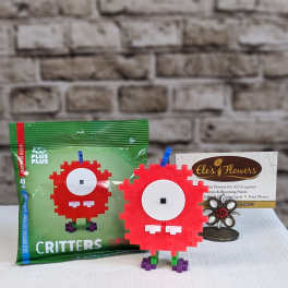 Toy building-block critter figures beside packaged blocks and a flower shop card