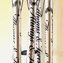 Black memorial wind chime with silver tubes and a heart pendant
