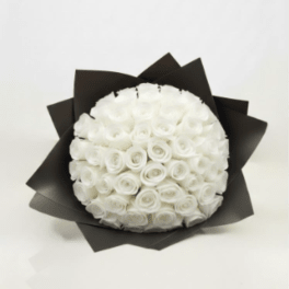 Round bouquet of white roses wrapped in black paper