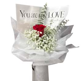 Red rose bouquet with white baby's breath in silver wrapping