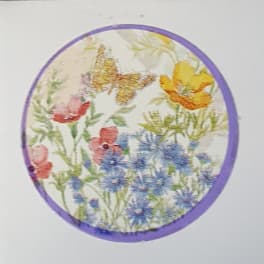 Round floral print with butterflies and colorful flowers in a purple border
