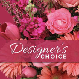 Bright pink and coral arrangement with roses, gerbera daisies and tulips with 'Designer’s Choice' text overlay.