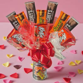 Candy bouquet in a glass jar with a red bow
