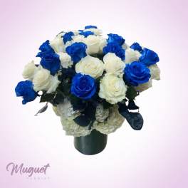 Bouquet of blue and white roses in a dark vase