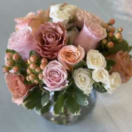 Bouquet of pink and white roses in a glass vase