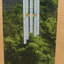 Silver wind chime with a wooden top and prayer tag