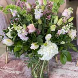 Mixed bouquet of pink and white flowers in a glass vase