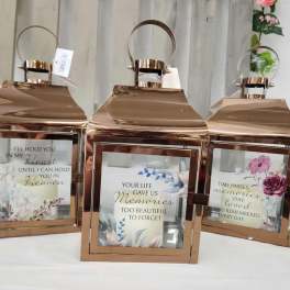 Three rose-gold lanterns with memorial quote inserts