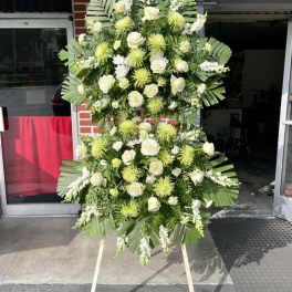 Tall standing floral spray with white roses and green chrysanthemums