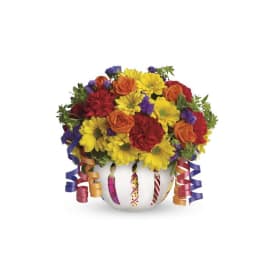 Colorful bouquet in a white vase with curling ribbon streamers