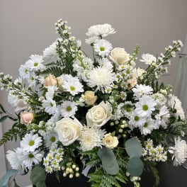 White daisies and cream roses arranged in a large bouquet