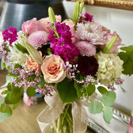 Pink and white mixed bouquet in a glass vase with a burlap ribbon